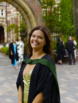 Maddie  waits her turn for a snap under 'the' arch.